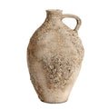 Textured ceramic vase with a handle on a white background