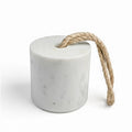 Decorative terrazzo door stop featuring a cylindrical silhouette and natural braided rope handle. Functional home accent with a speckled stone finish, designed to hold doors open while adding timeless style