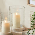 Clear glass hurricane candle holders with warm candlelight and timeless neutral styling for cozy European-inspired interiors | Sorelle Rossi Shoppe
