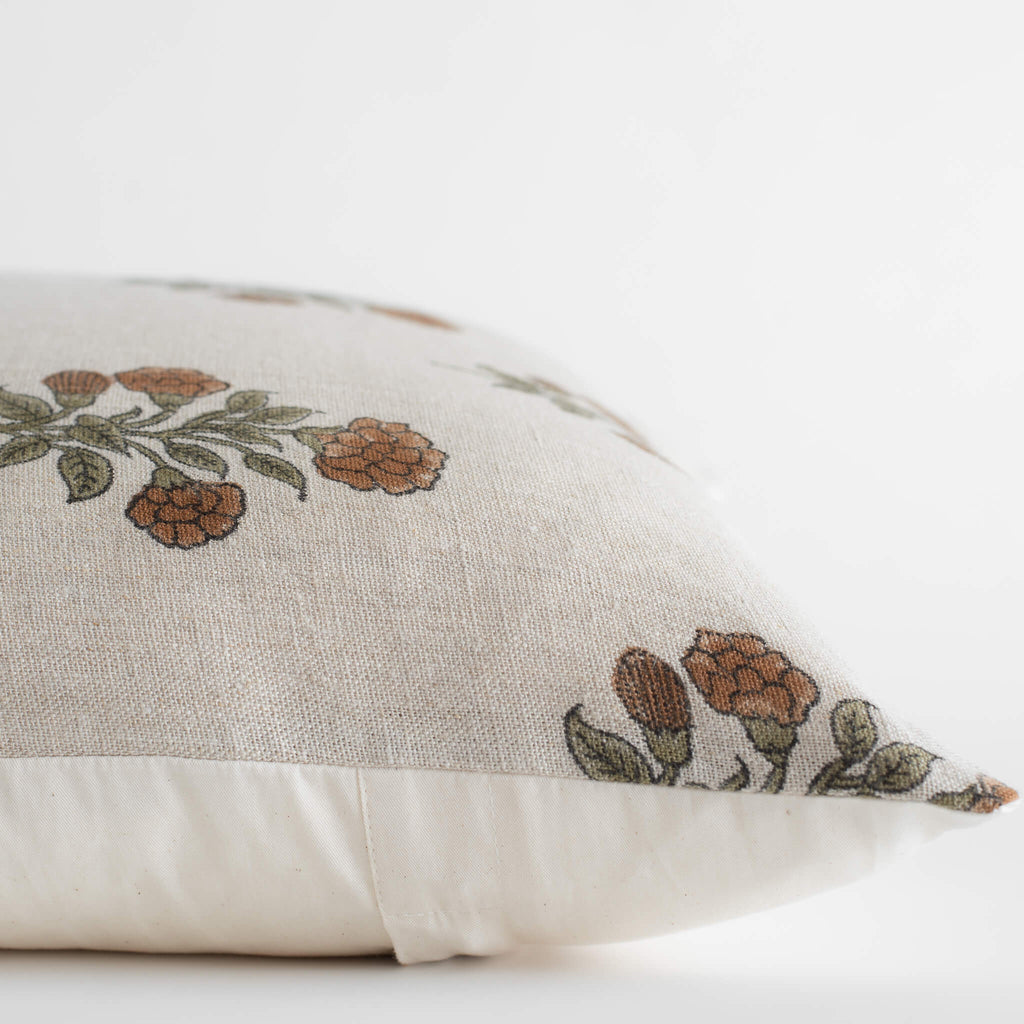 Decorative pillow with floral embroidery on a white background