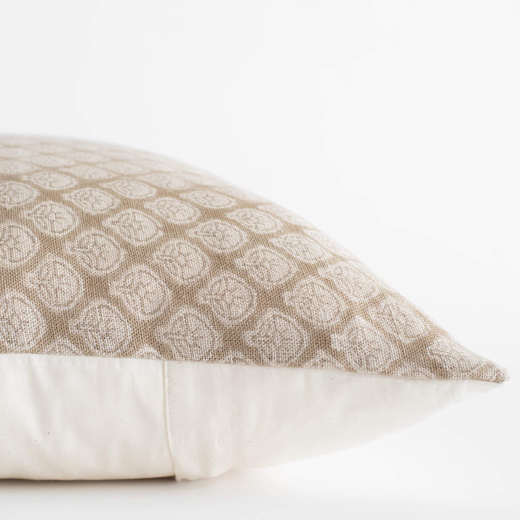 Patterned beige pillow on a white background