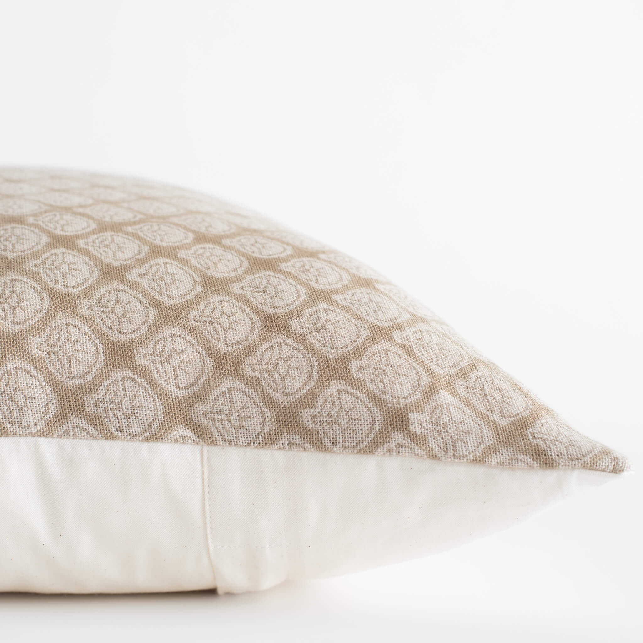 Patterned beige pillow on a white background