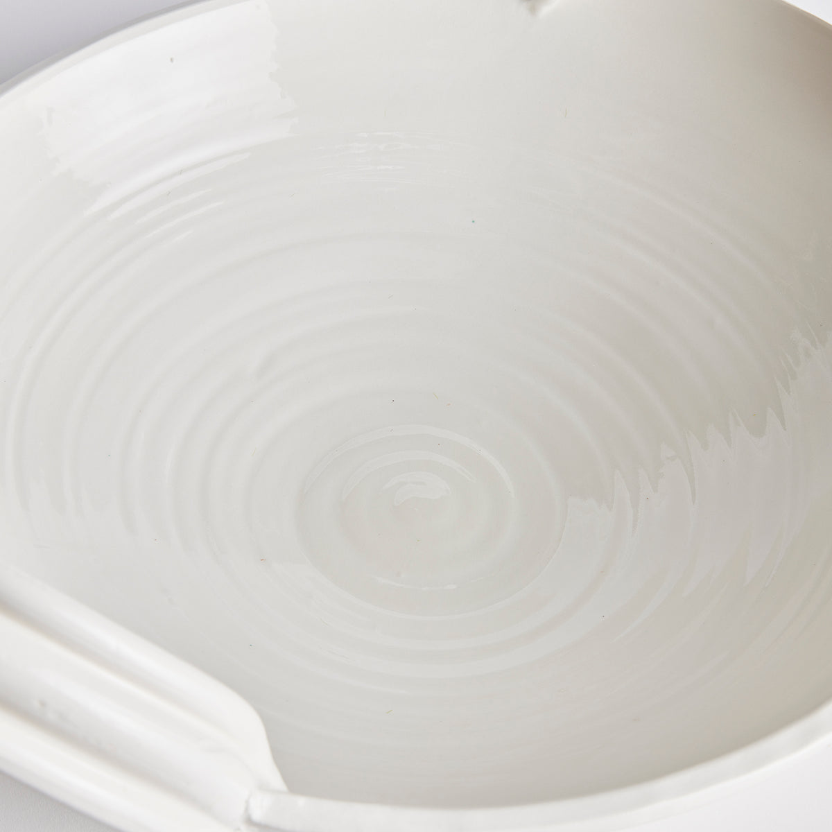 Close-up of a white ceramic bowl with subtle texture
