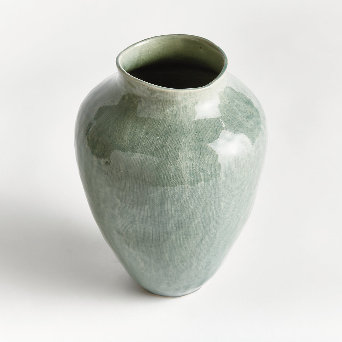 Green ceramic vase on a white background