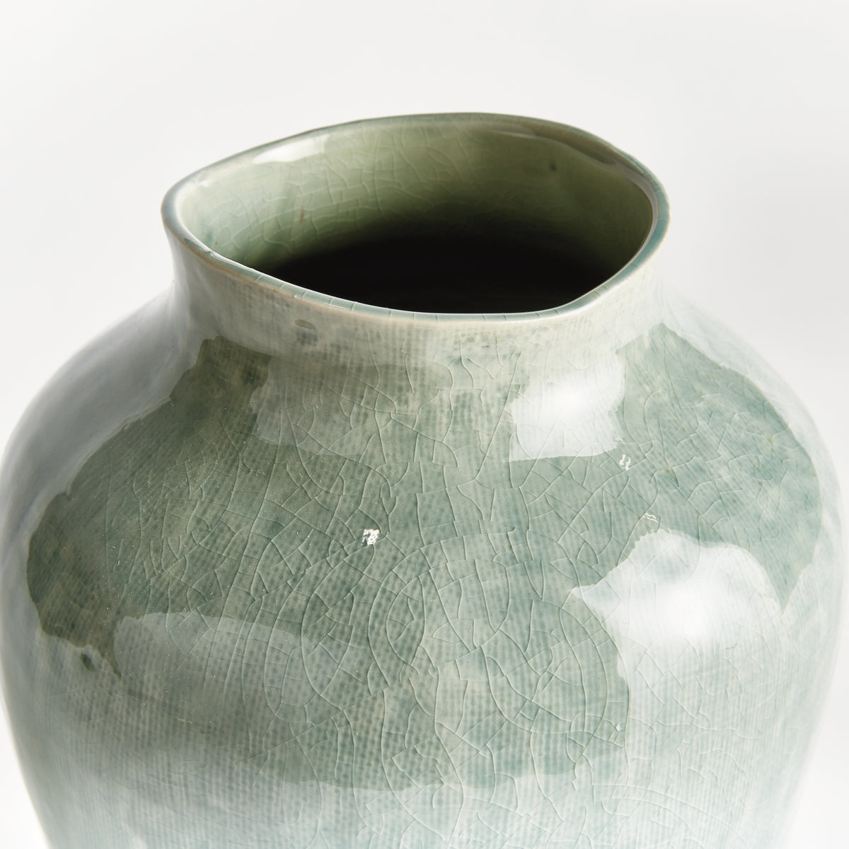 Green ceramic vase on a white background
