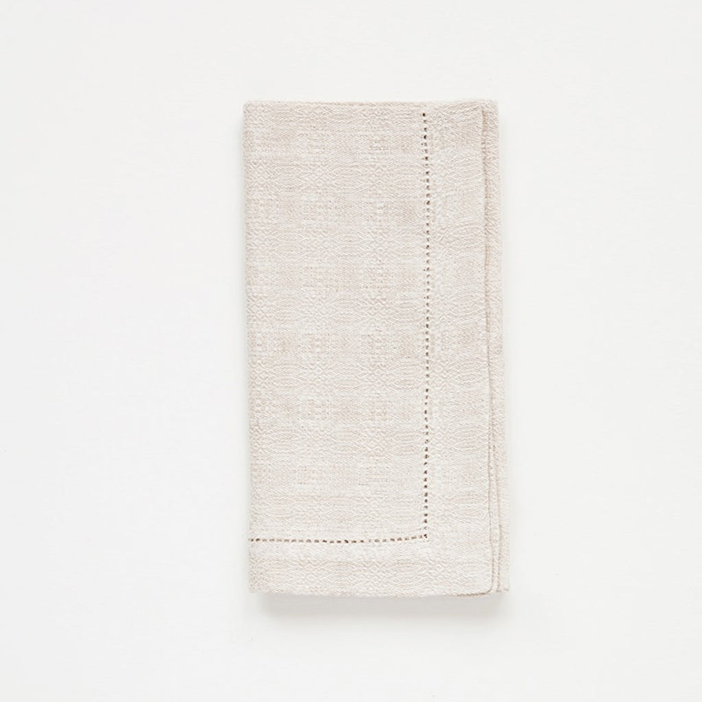Folded beige napkin on a white background