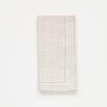 Folded beige napkin on a white background