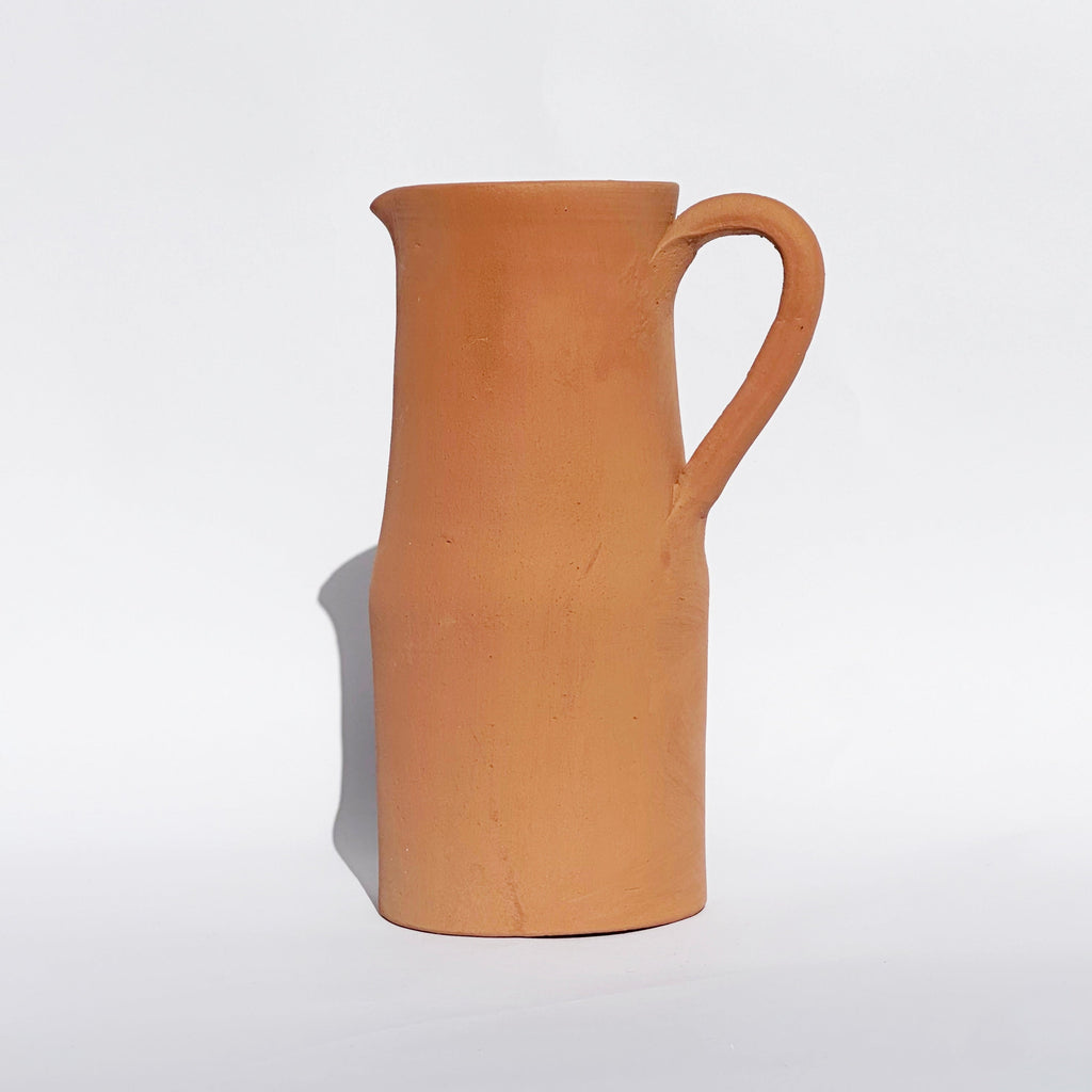 Alt Text: Handcrafted Mediterranean terracotta pitcher with curved handle, warm clay finish, and rustic European-inspired styling | Sorelle Rossi Shoppe