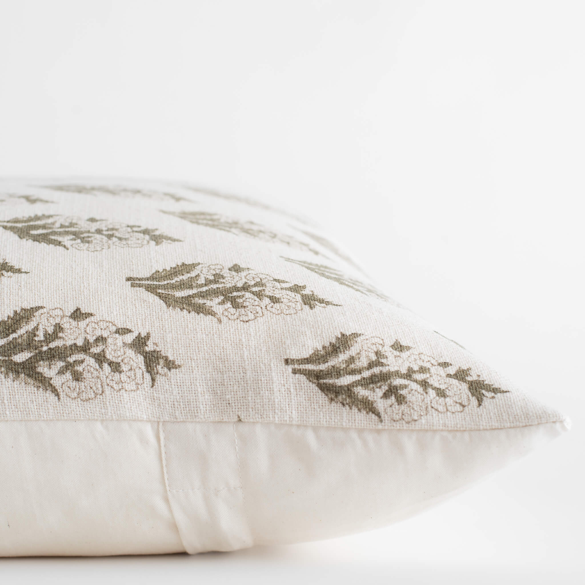 Decorative pillow with leaf pattern on a white background
