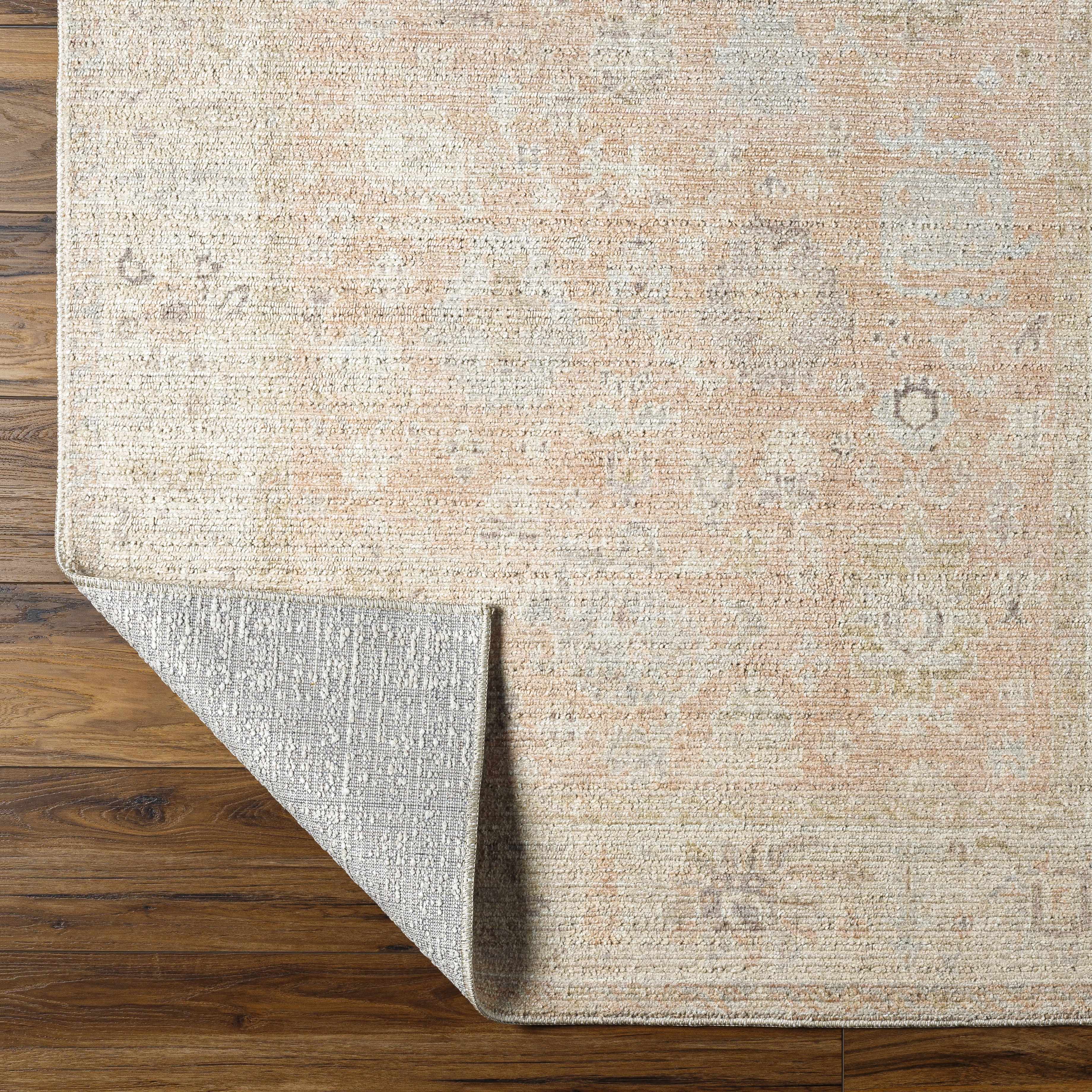 Textured beige rug on a wooden floor