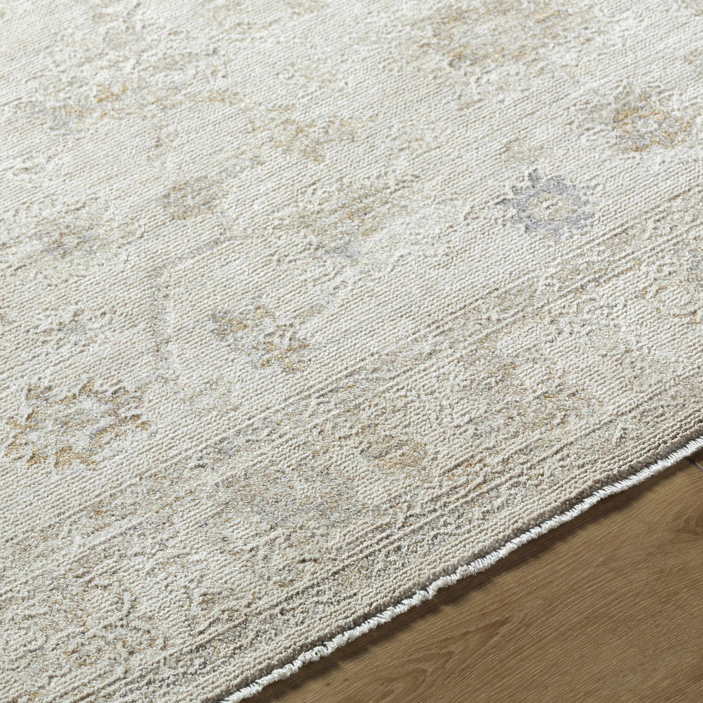 Close-up of a textured beige rug on a wooden floor