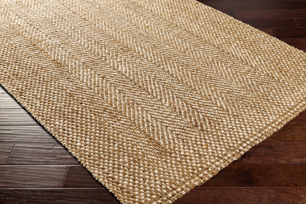 Beige woven rug on a wooden floor