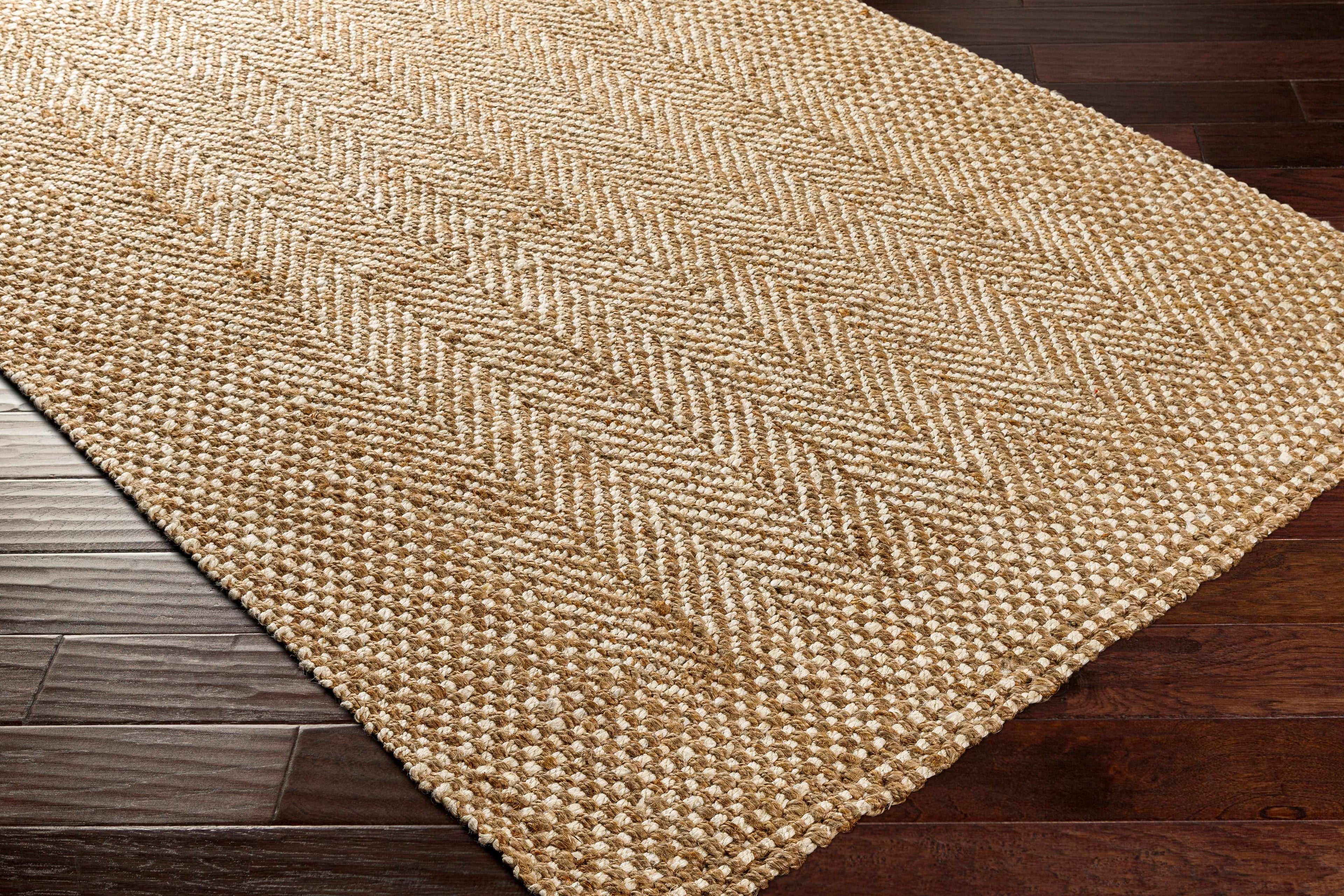 Beige woven rug on a wooden floor