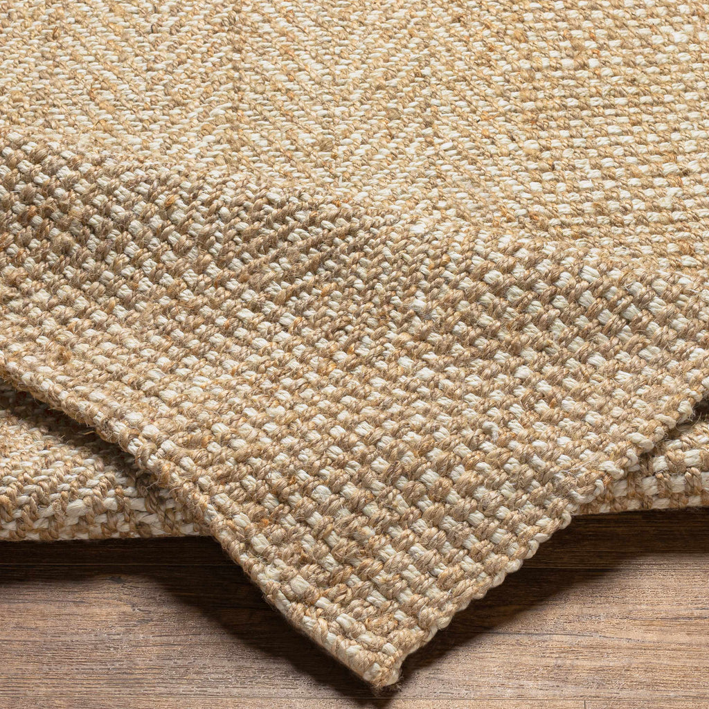 Close-up of a textured beige carpet on a wooden floor