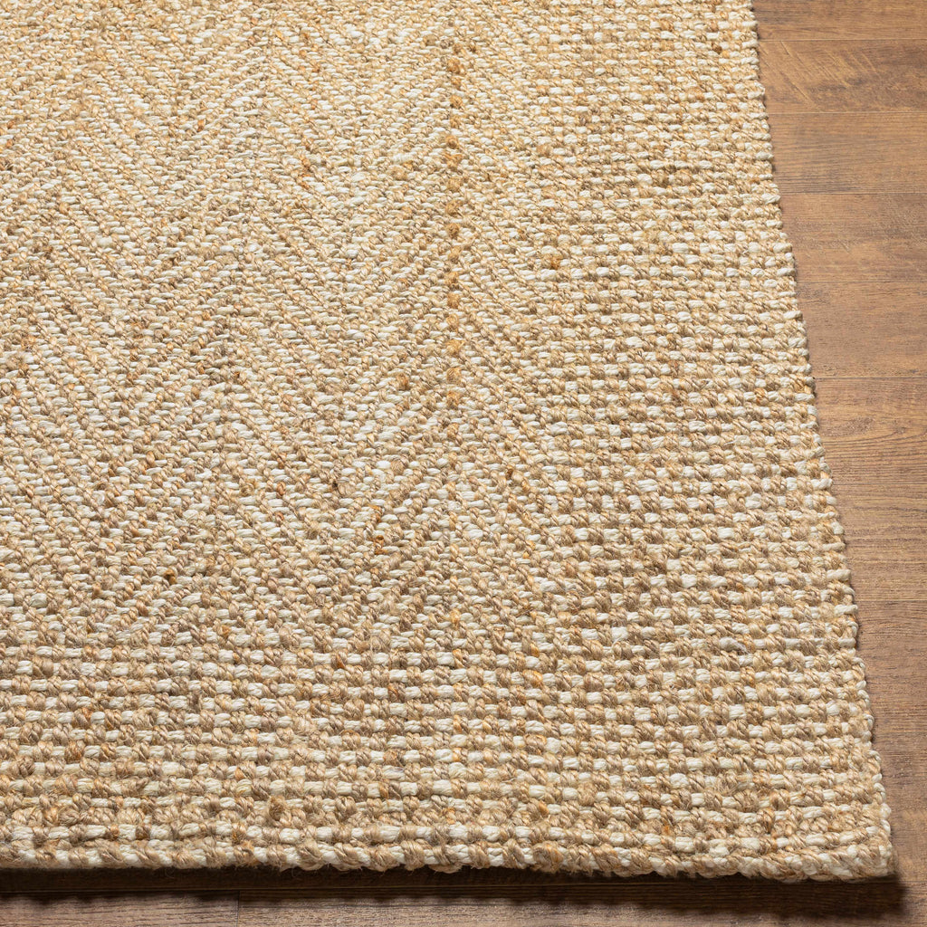 Textured beige rug on a wooden floor