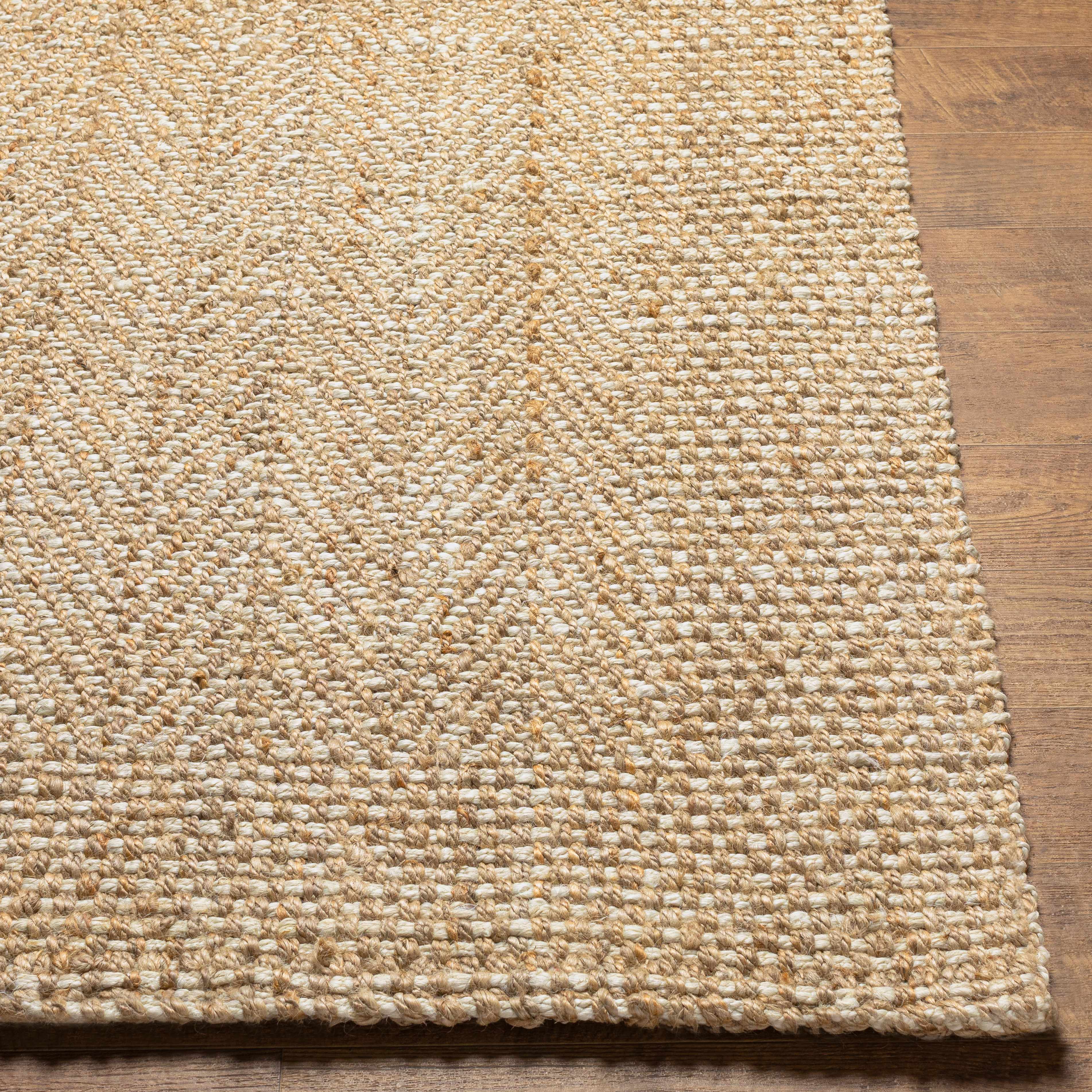 Textured beige rug on a wooden floor