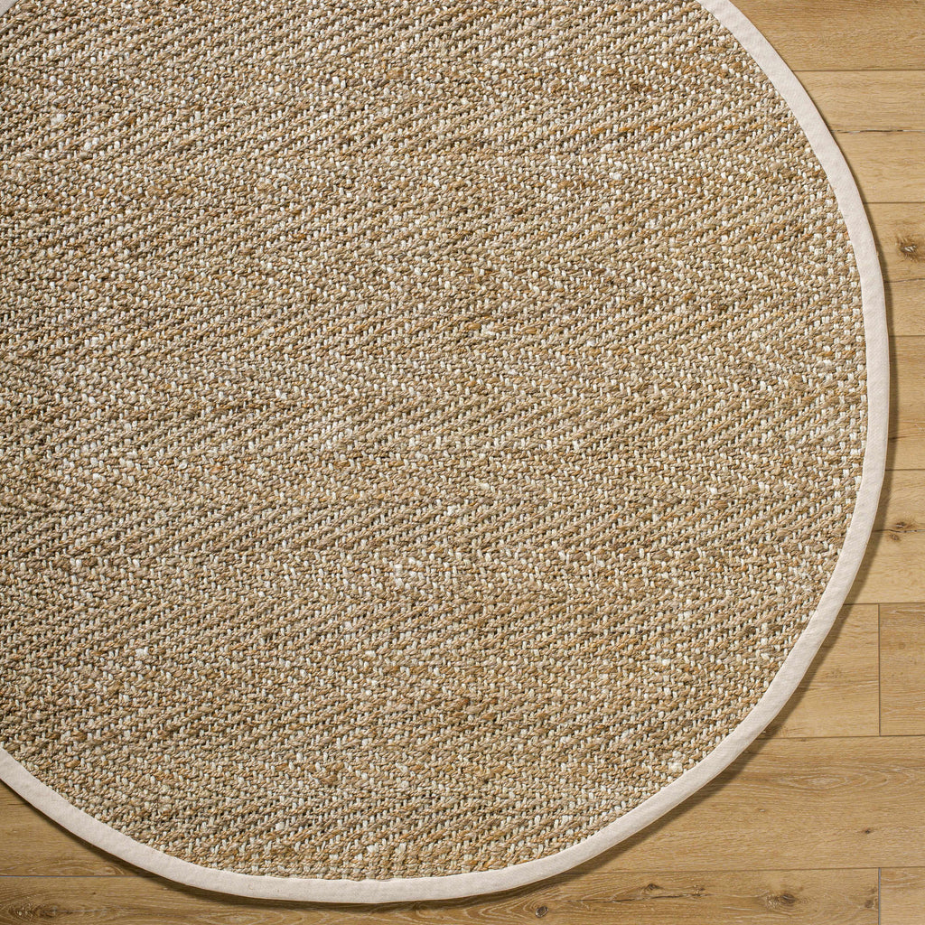 Round beige rug on a wooden floor