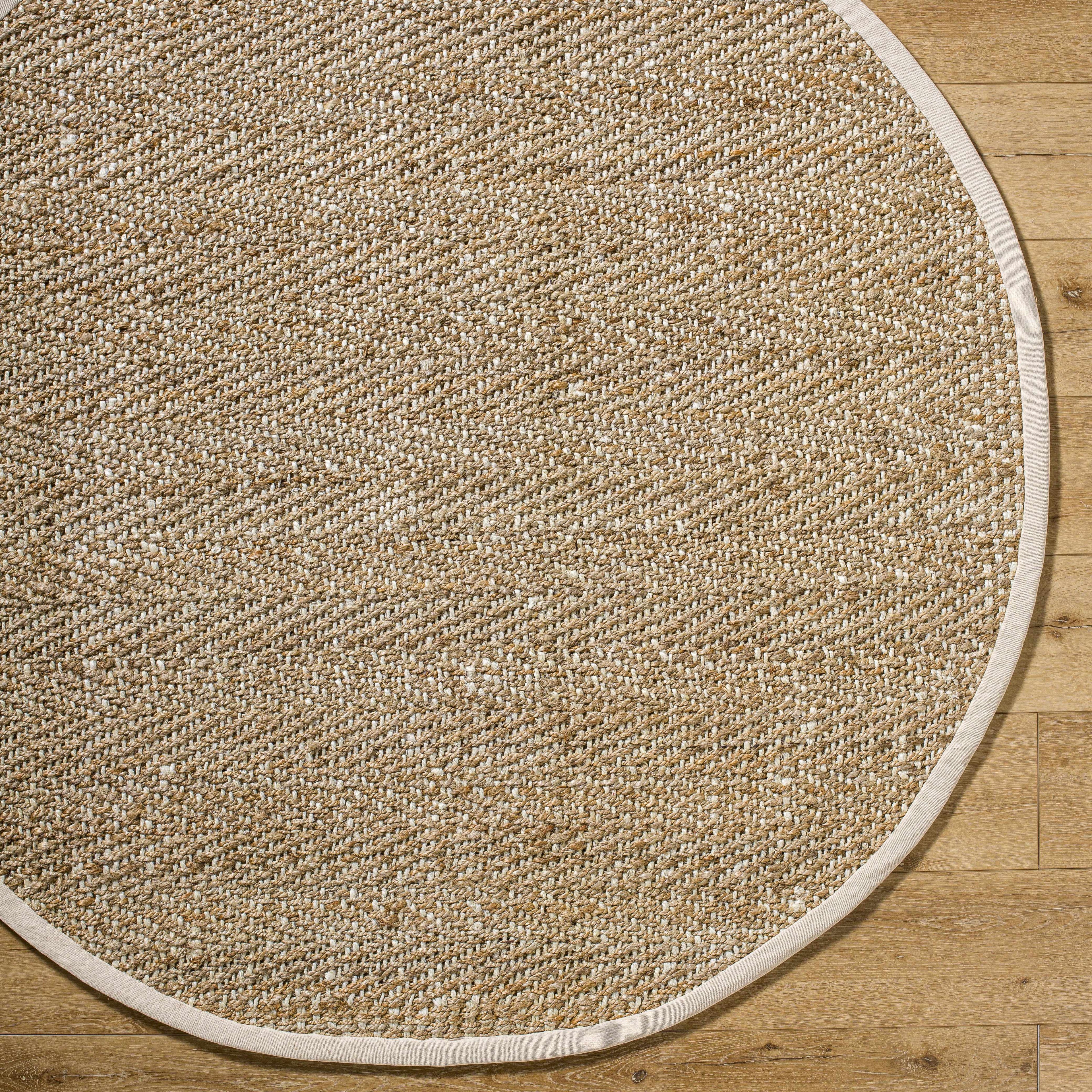 Round beige rug on a wooden floor