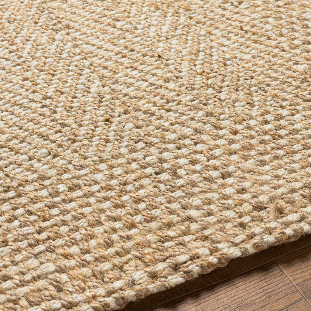 Close-up of a textured beige rug on a wooden floor