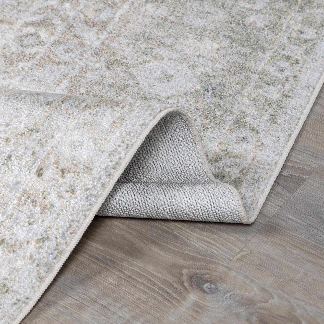 Textured beige rug on a wooden floor