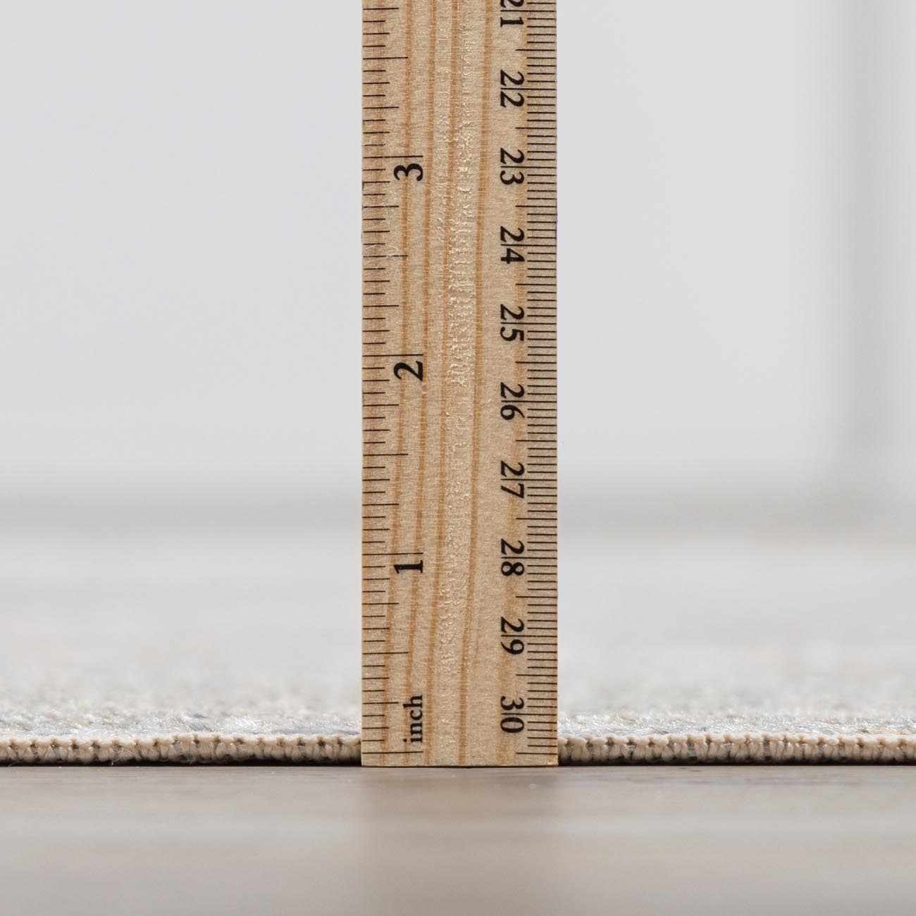 Wooden ruler on a textured white surface