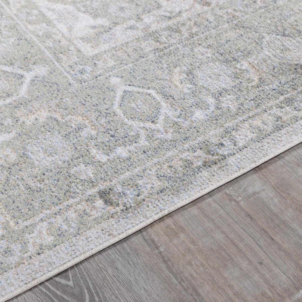 Close-up of a textured gray rug on a wooden floor