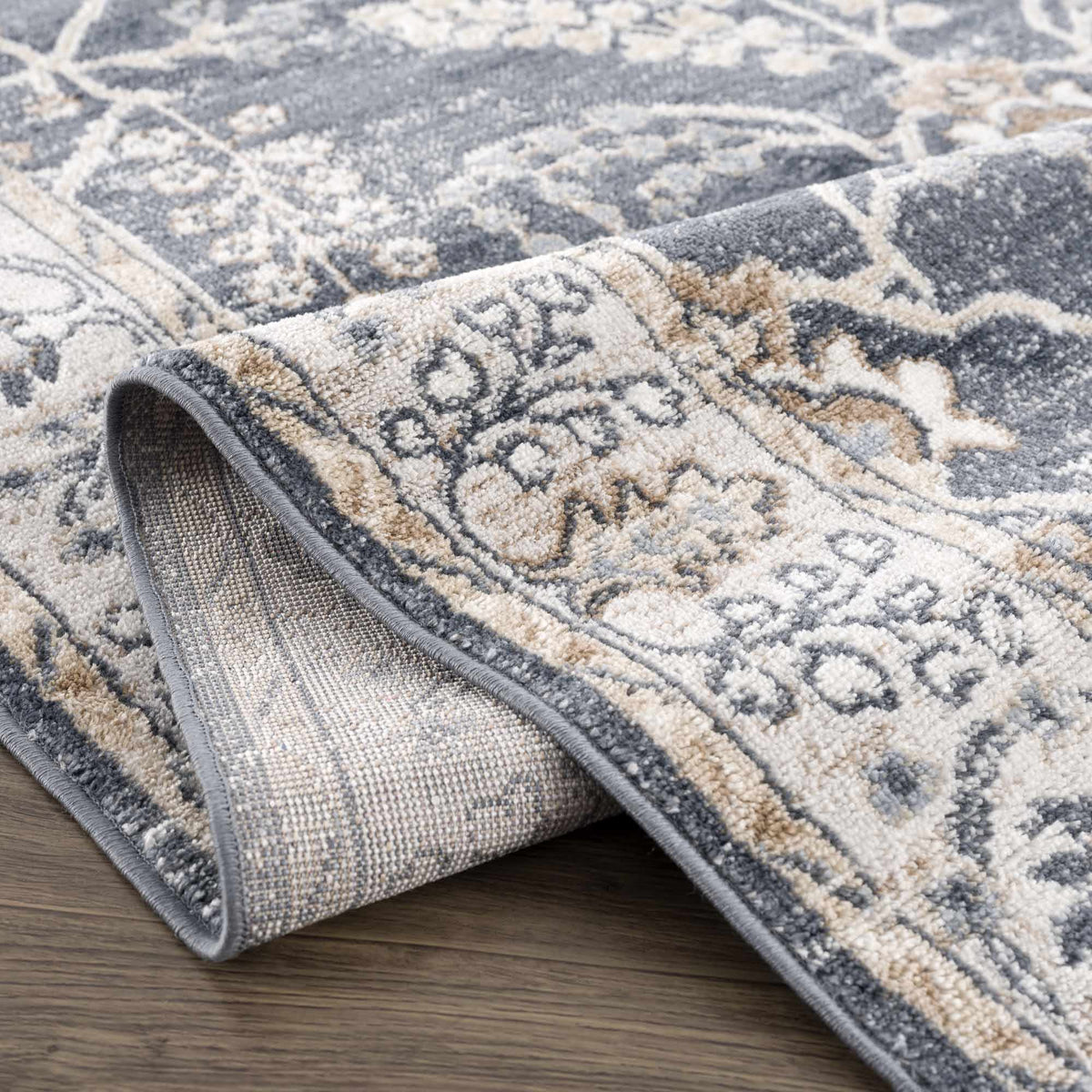 Decorative rug with intricate patterns on a wooden floor