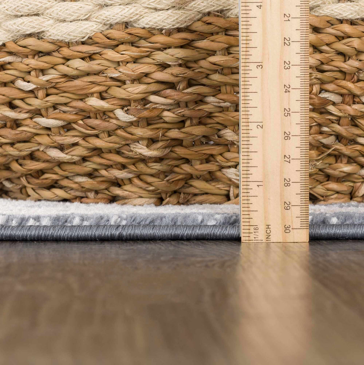 Woven mat with a ruler showing measurements on a wooden surface