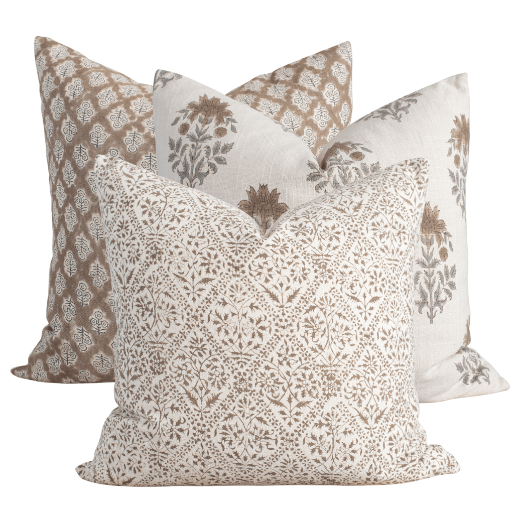Set of four patterned pillows on a white background
