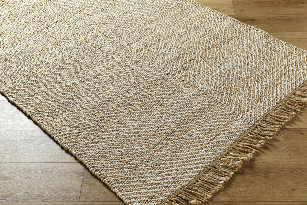Beige woven rug with a textured pattern on a wooden floor