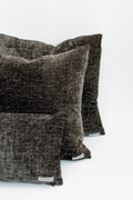 Two dark gray textured pillows on a white background