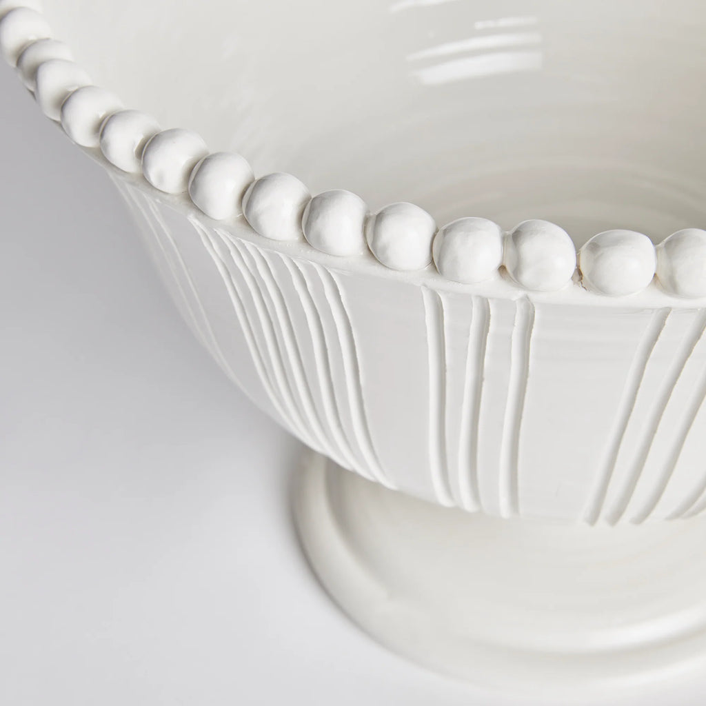 Elegant white ceramic pedestal bowl with fluted detailing and decorative beaded rim for timeless European-inspired tabletop styling | Sorelle Rossi Shoppe