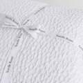 Cozy white waffle weave throw blanket tied with Sorelle Rossi ribbon and styled with timeless European-inspired neutral texture | Sorelle Rossi Shoppe