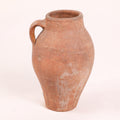 Terracotta jar with a single handle on a white background
