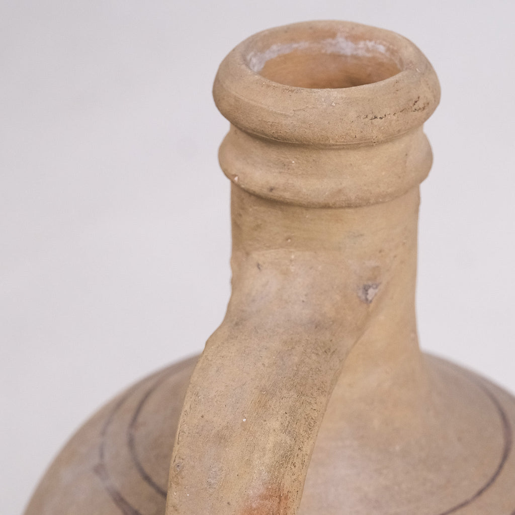 Close-up of a brown ceramic bottle with a plain background