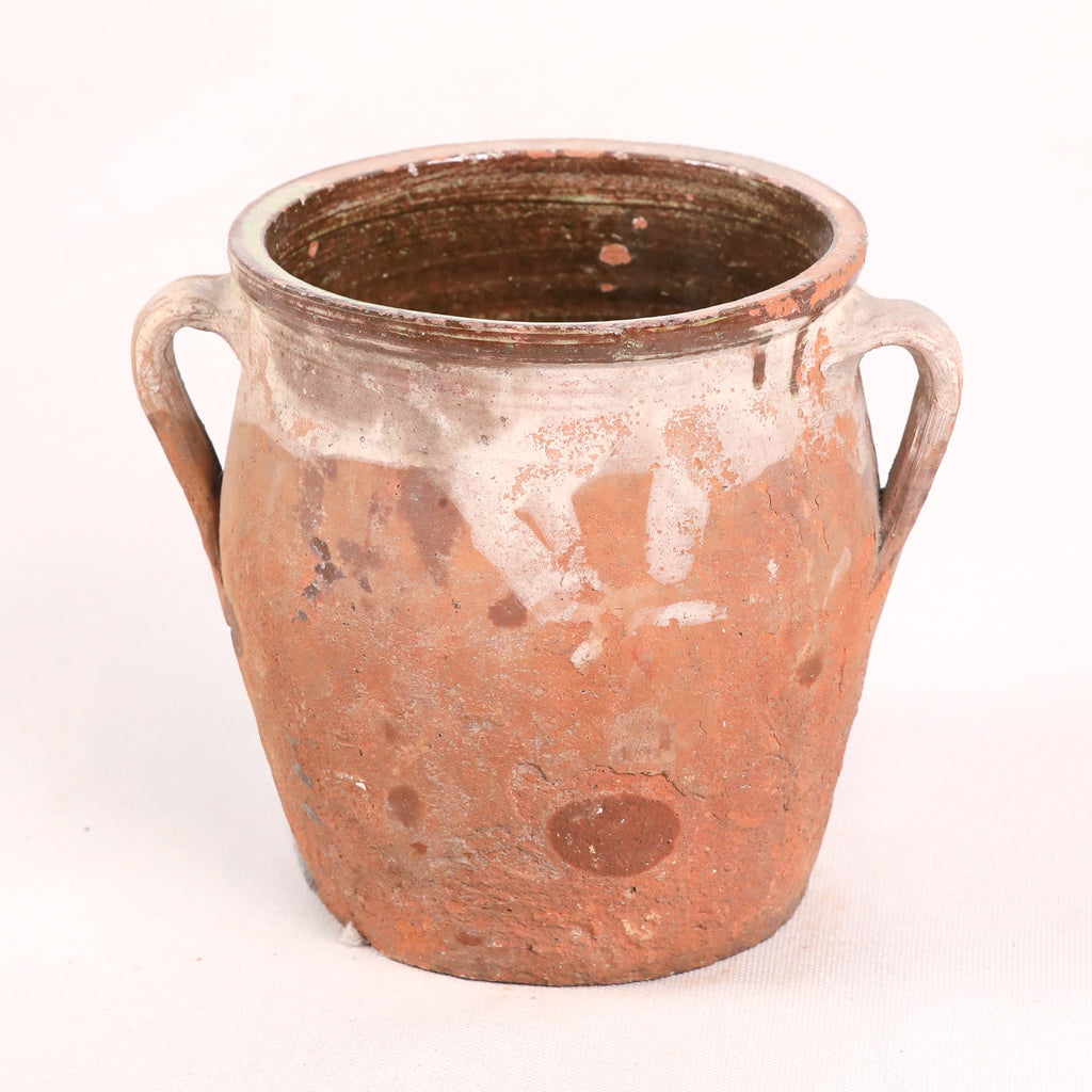Terracotta pot with handles on a white background