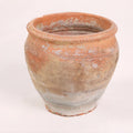 Terracotta pot with a textured surface on a white background