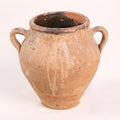 Ancient terracotta jar with two handles on a white background