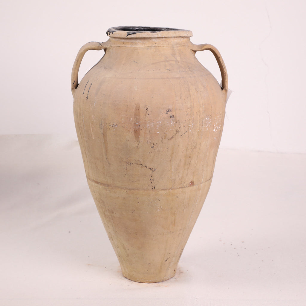 Beige ceramic jar with handles on a white background