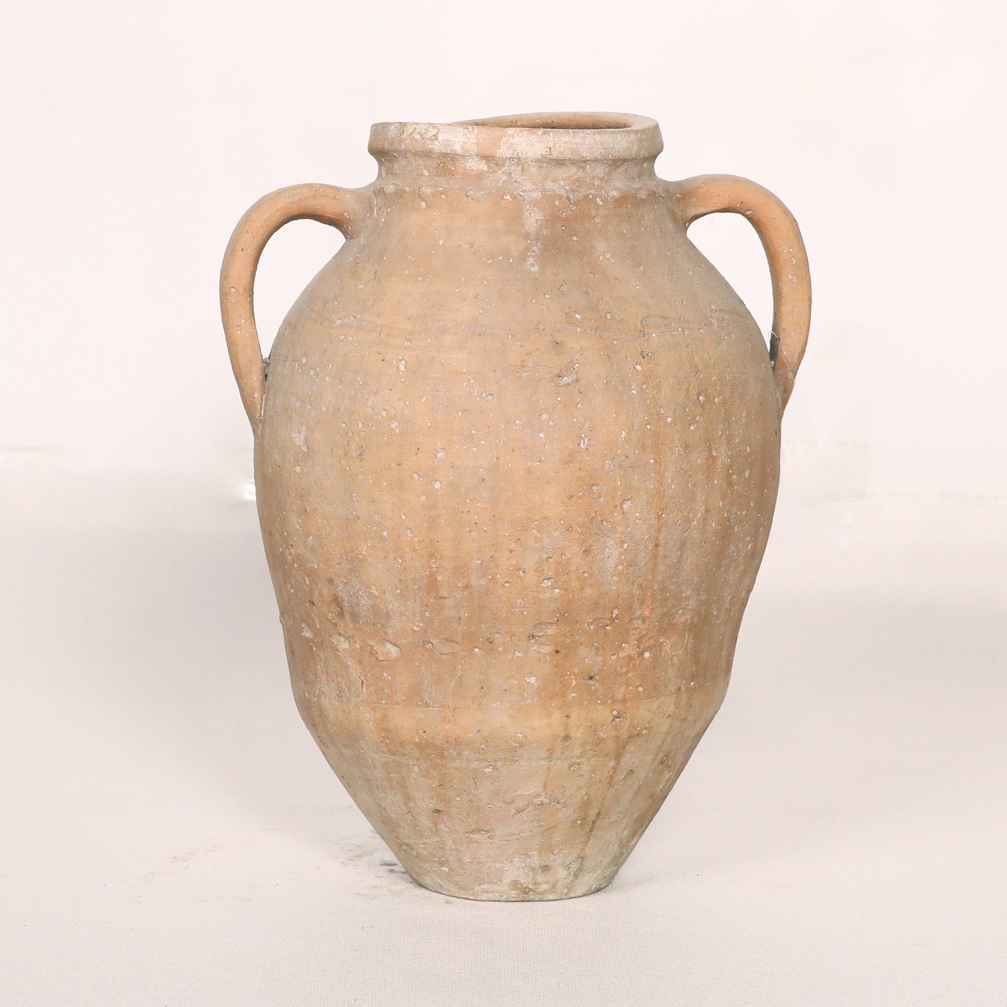 Terracotta jar with handles on a white background