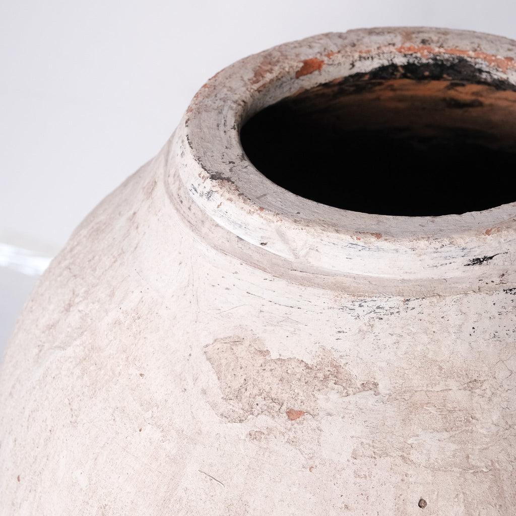 Close-up of a textured ceramic pot with a white background