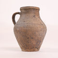 Brown ceramic pitcher on a white background