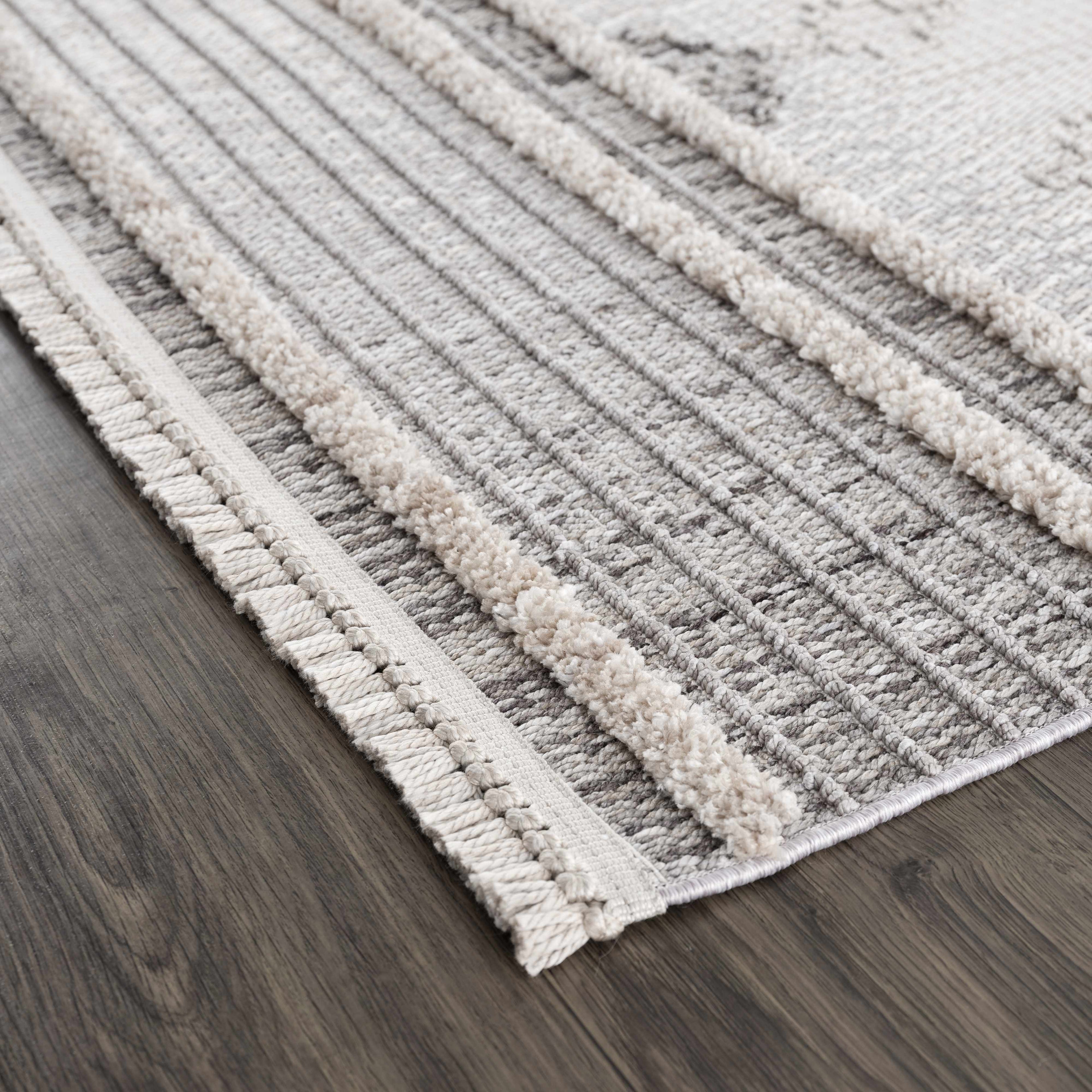 Textured area rug with striped pattern on a wooden floor
