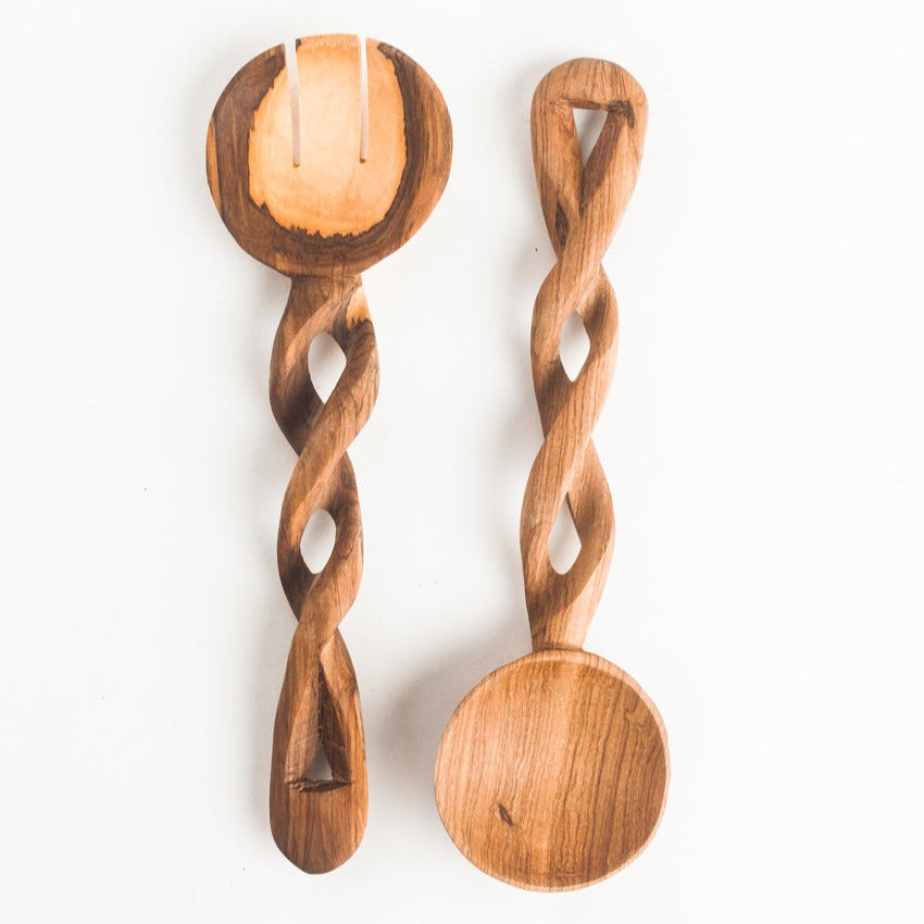 Two handcrafted wooden spoons with twisted handles and oval bowls, displayed on a clean white background.