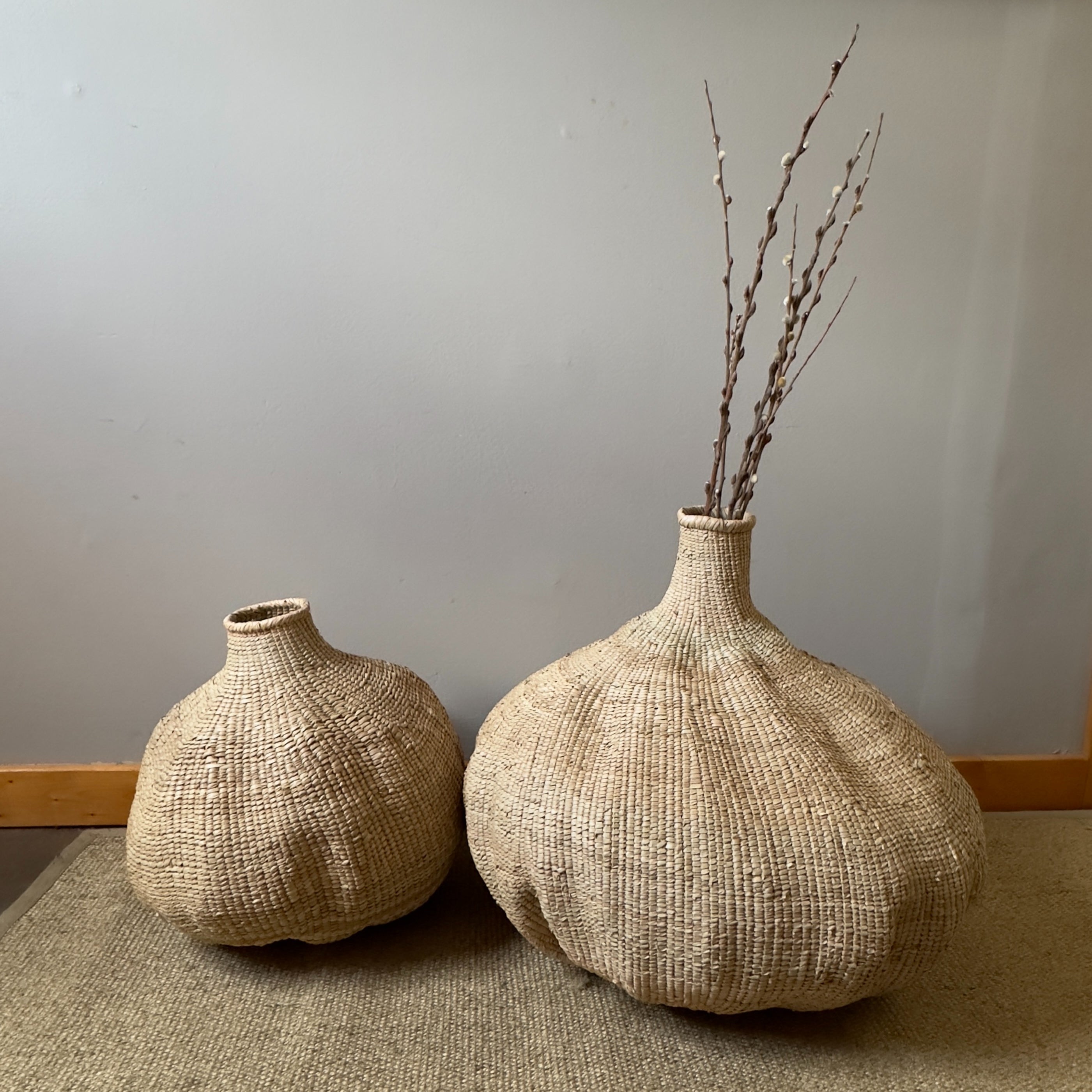 Woven beige vase on a white background