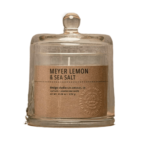 Candle jar labeled 'Meyer Lemon & Sea Salt' with a rustic design on a white background