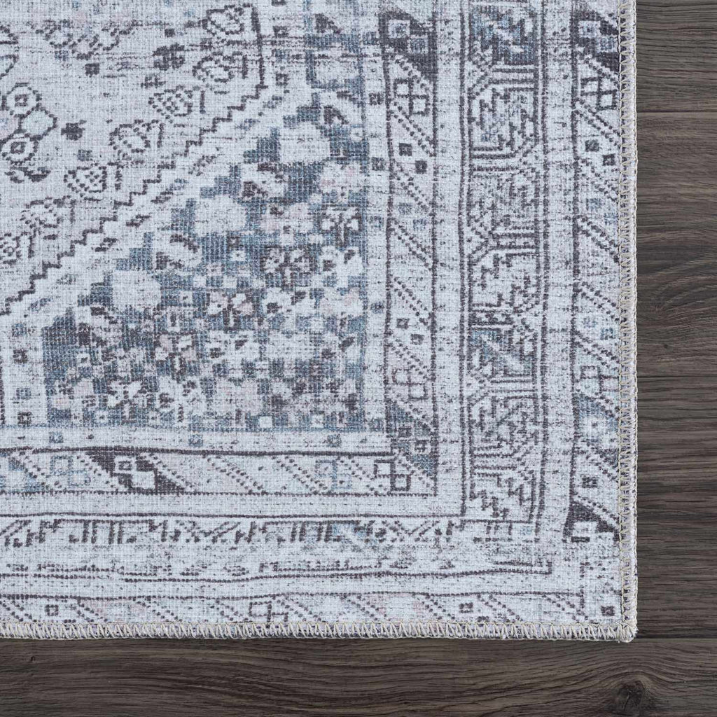Close-up of a patterned rug on a wooden floor