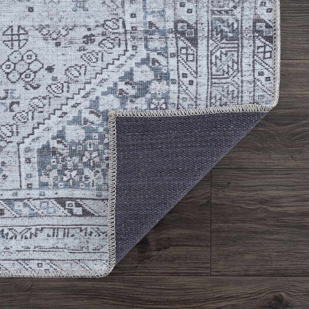 Patterned rug on a wooden floor