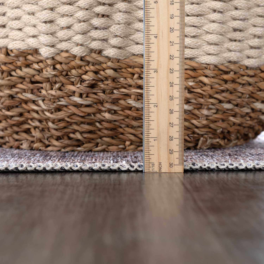 Rug with a ruler showing measurements on a wooden floor