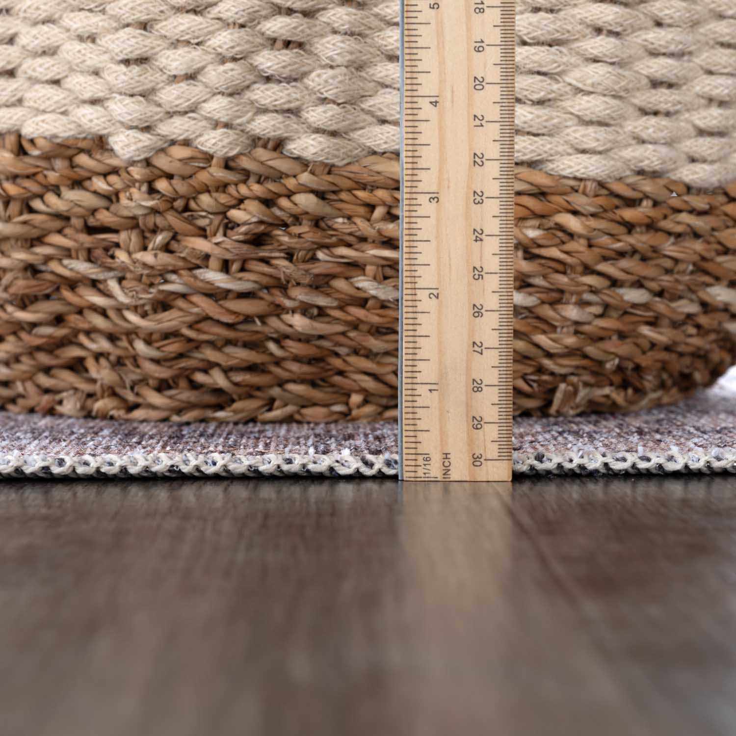 Rug with a ruler showing measurements on a wooden floor